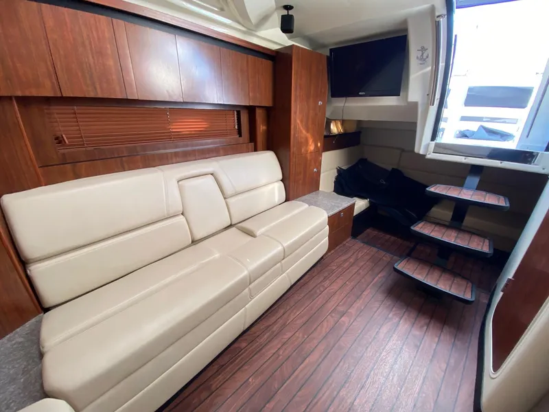 Slide: The Image of Interior of 2015 Monterey 335 Sport Yacht with beige seating and wooden accents. - 18