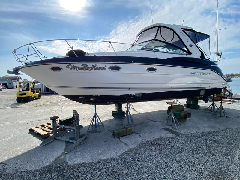Slide: The Image of 2015 Monterey 335 Sport Yacht on stands at a marina, side view. - 2