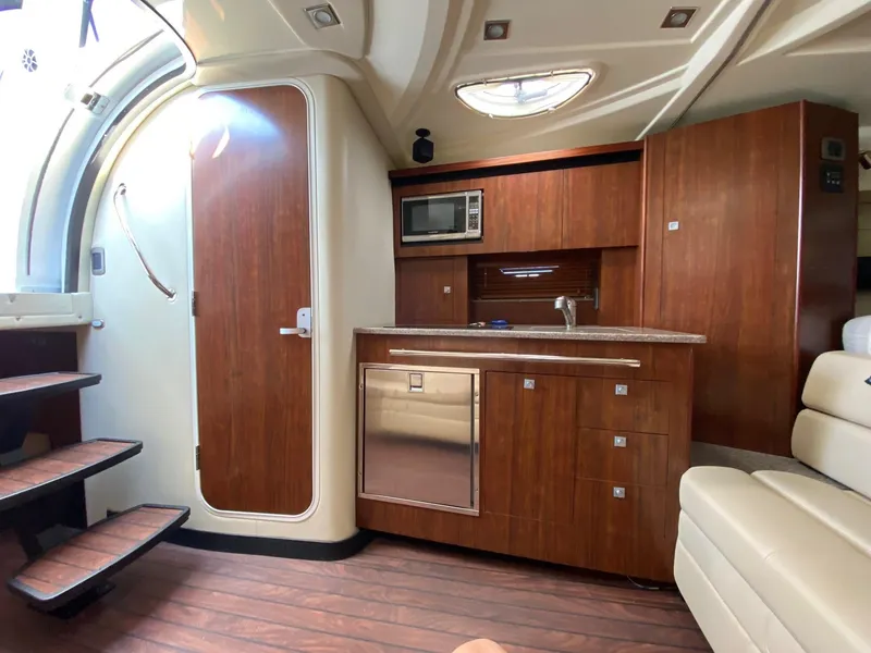 Slide: The Image of Interior of 2015 Monterey 335 Sport Yacht with wood cabinetry and modern amenities. - 20