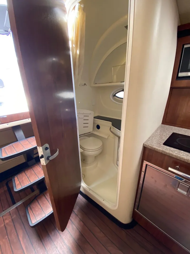 Slide: The Image of Interior of 2015 Monterey 335 Sport Yacht showing bathroom and kitchenette. - 21