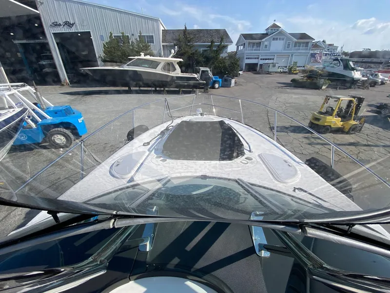 Slide: The Image of 2015 Monterey 335 Sport Yacht at marina, surrounded by boats and equipment. - 23