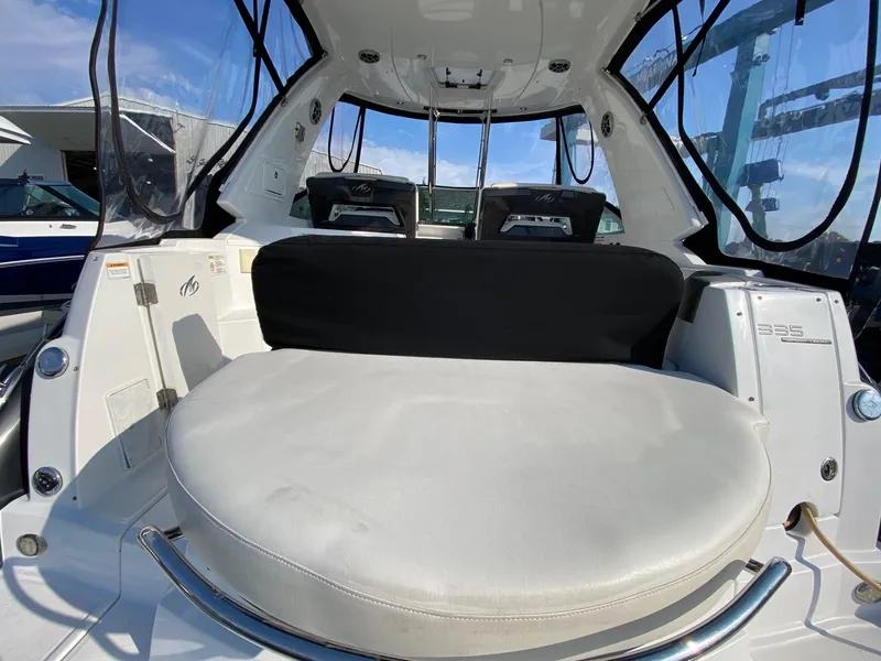 Slide: The Image of 2015 Monterey 335 Sport Yacht interior with seating, clear windows, and sleek design. - 25