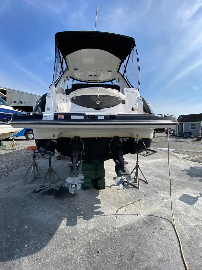 Slide: The Image of 2015 Monterey 335 Sport Yacht on stands, rear view, under clear blue sky. - 3