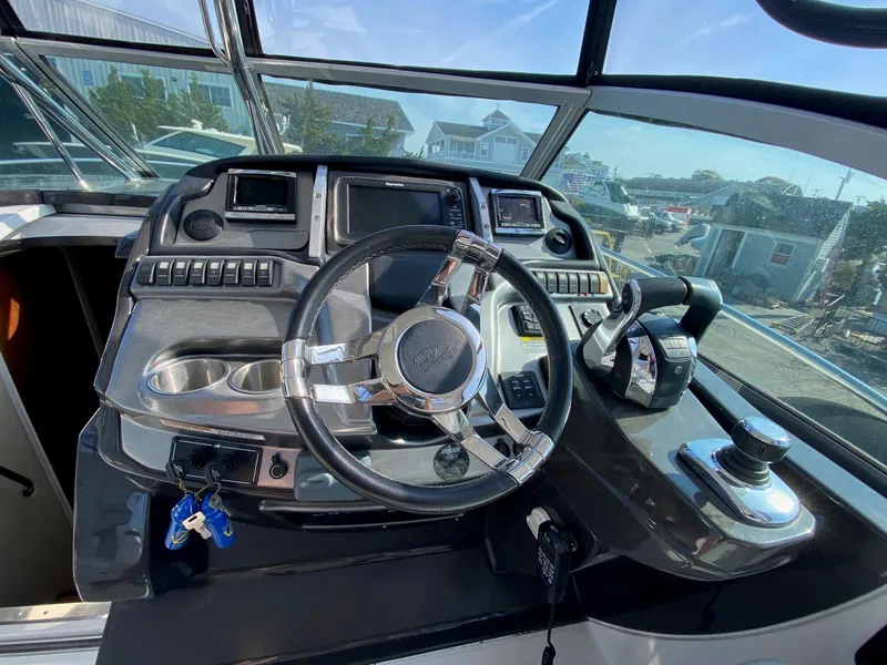 Slide: The Image of Helm of 2015 Monterey 335 Sport Yacht with steering wheel and control panel. - 5
