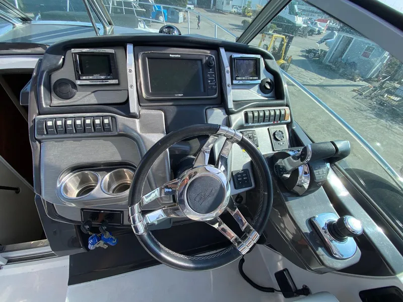 Slide: The Image of Control panel of 2015 Monterey 335 Sport Yacht with steering wheel and navigation displays. - 6