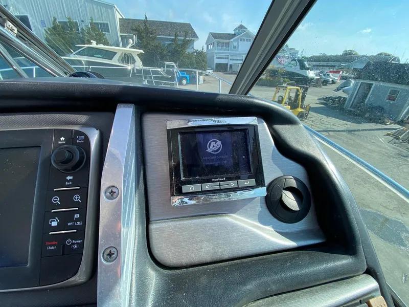 Slide: The Image of Dashboard of a 2015 Monterey 335 Sport Yacht with navigation controls and display. - 8