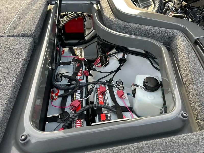 Slide: The Image of 2024 iKon LX21 battery compartment with wiring and fluid reservoir. - 10