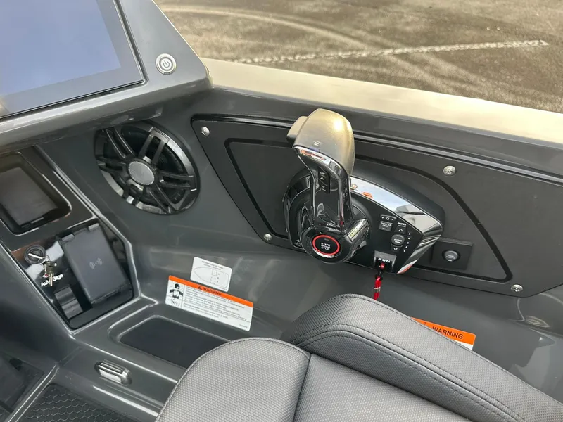 Slide: The Image of 2024 iKon LX21 boat control panel with throttle and speaker. - 12