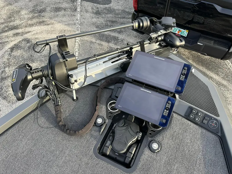 Slide: The Image of Fishing boat electronics setup with dual screens and trolling motor, iKon LX21, 2024 model. - 2