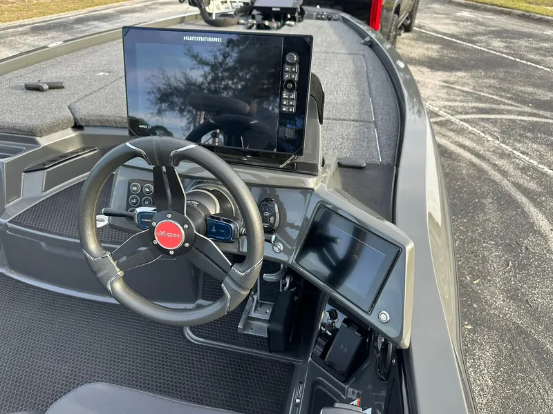 Slide: The Image of 2024 iKon LX21 boat dashboard with steering wheel and advanced navigation screens. - 4
