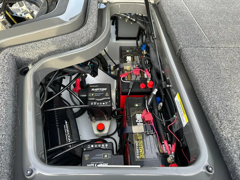 Slide: The Image of 2024 iKon LX21 battery compartment with multiple batteries and wiring setup. - 9