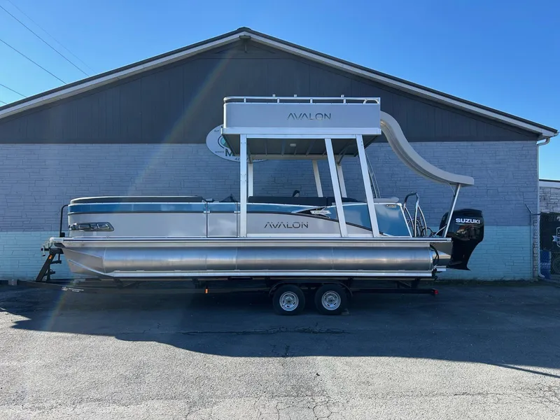 The Image of 2025 Avalon Catalina 2585 Funship Cruise pontoon boat with slide, parked on trailer. - 1