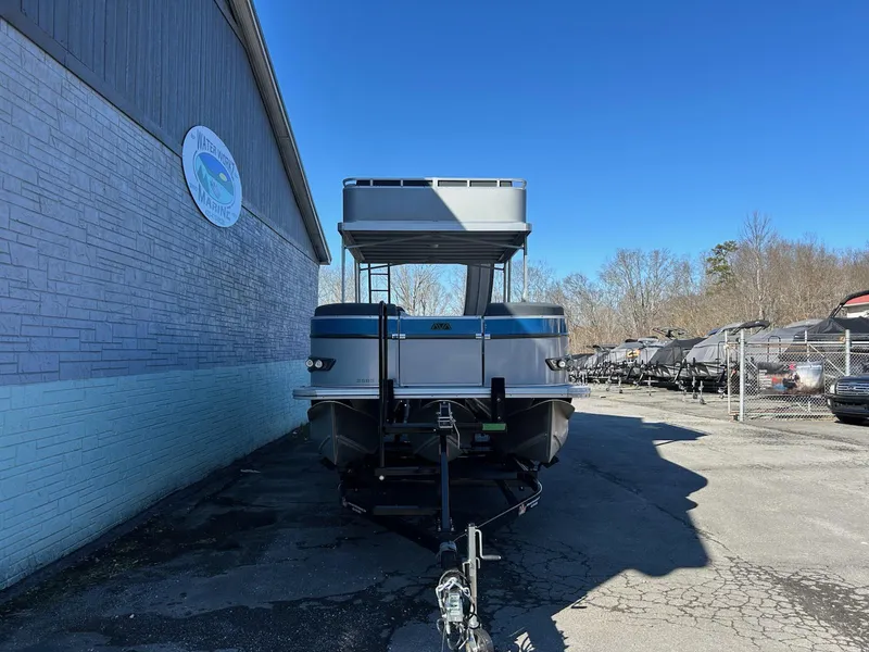 Slide: The Image of 2025 Avalon Catalina 2585 Funship Cruise boat parked outside a building on a sunny day. - 3