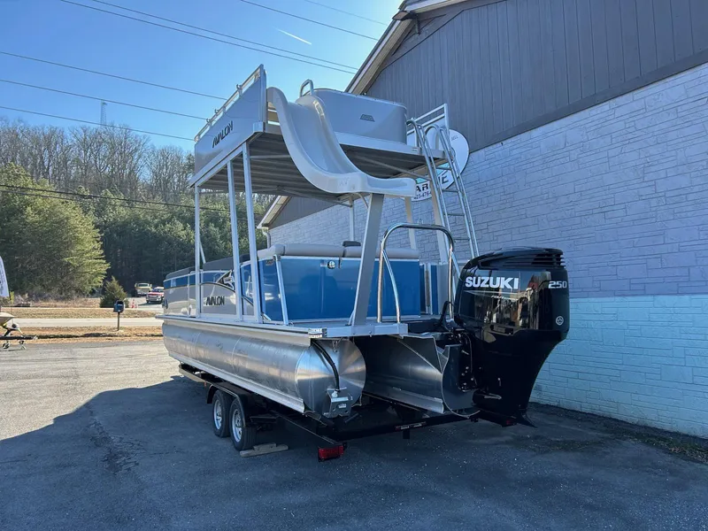 Slide: The Image of 2025 Avalon Catalina 2585 Funship Cruise pontoon boat with Suzuki engine, parked outdoors. - 4