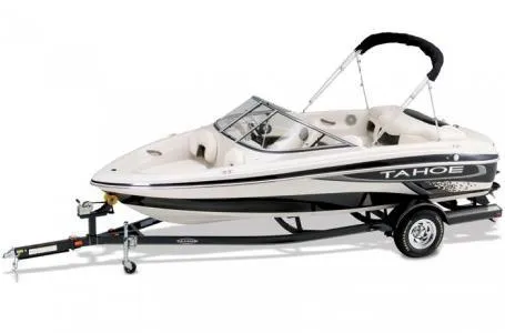 Slide: The Image of 2012 Tahoe Q4 SS boat on trailer, white with black accents, sleek design. - 11