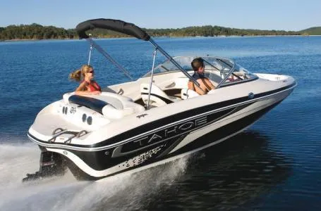 Slide: The Image of 2012 Tahoe Q4 SS boat cruising on a lake with two passengers. - 15