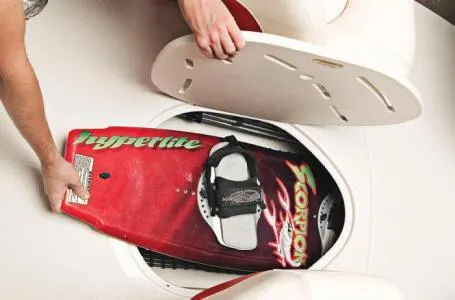 Slide: The Image of Storing a wakeboard in a 2012 Tahoe Q4 SS boat compartment. - 16