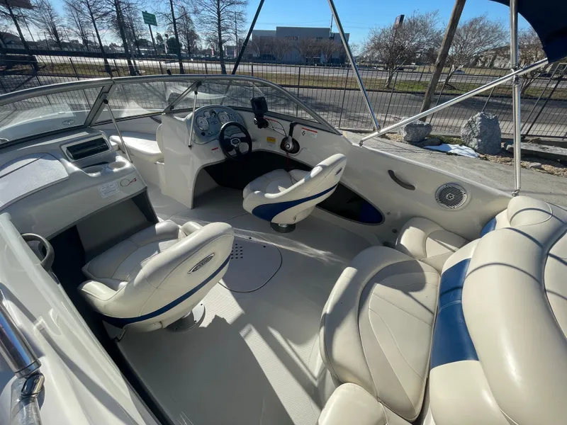Slide: The Image of 2012 Tahoe Q4 SS boat interior with white and blue seating, steering wheel, and dashboard. - 6