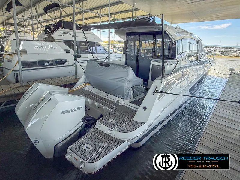 The Image of 2021 Four Winns Vista 355 Coupe OB docked, featuring Mercury outboard engines. - 0