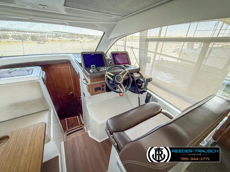 Slide: The Image of 2021 Four Winns Vista 355 Coupe OB interior with modern helm and navigation equipment. - 11