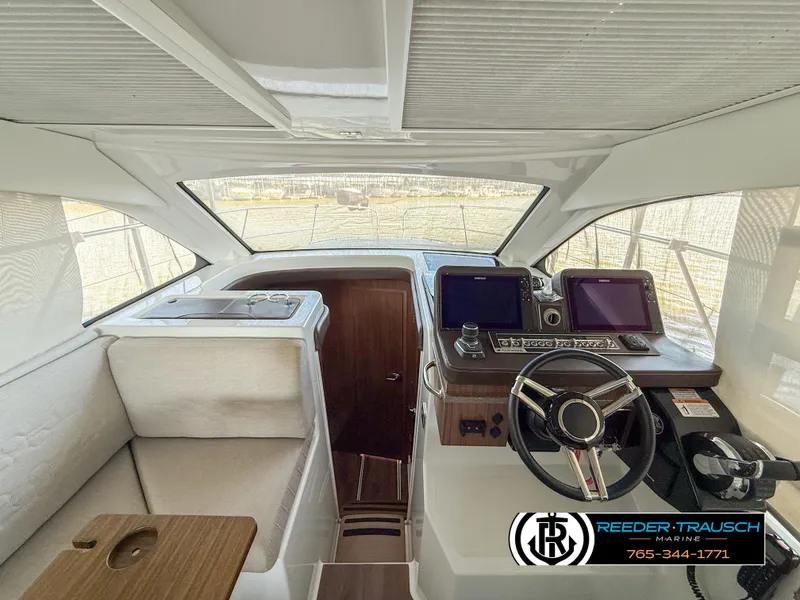 Slide: The Image of 2021 Four Winns Vista 355 Coupe OB helm with modern controls and sleek design. - 14