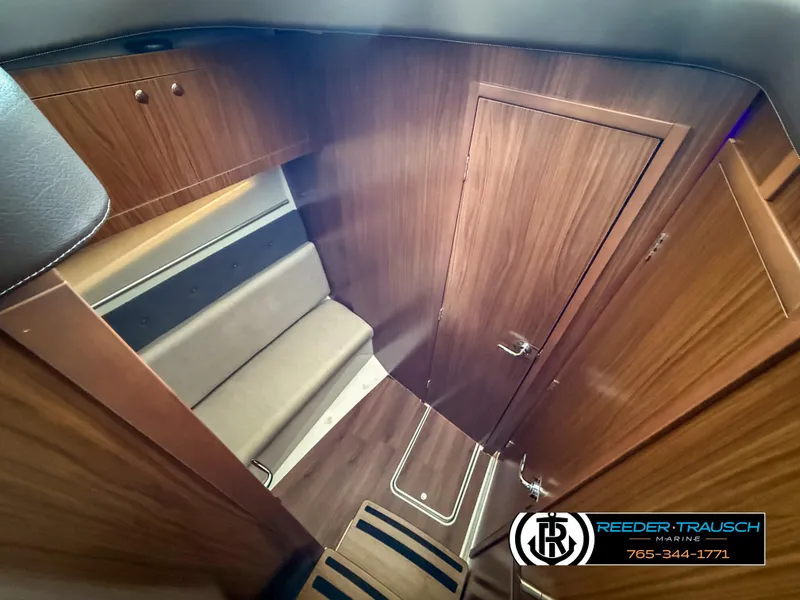 Slide: The Image of 2021 Four Winns Vista 355 Coupe OB interior with wood finish and seating area. - 15