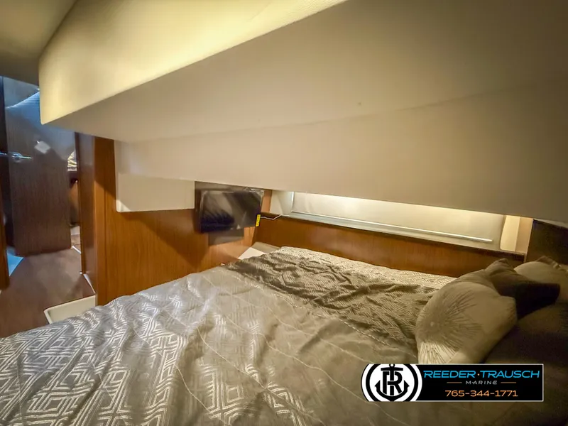 Slide: The Image of 2021 Four Winns Vista 355 Coupe OB cabin interior with cozy bed and modern design. - 18