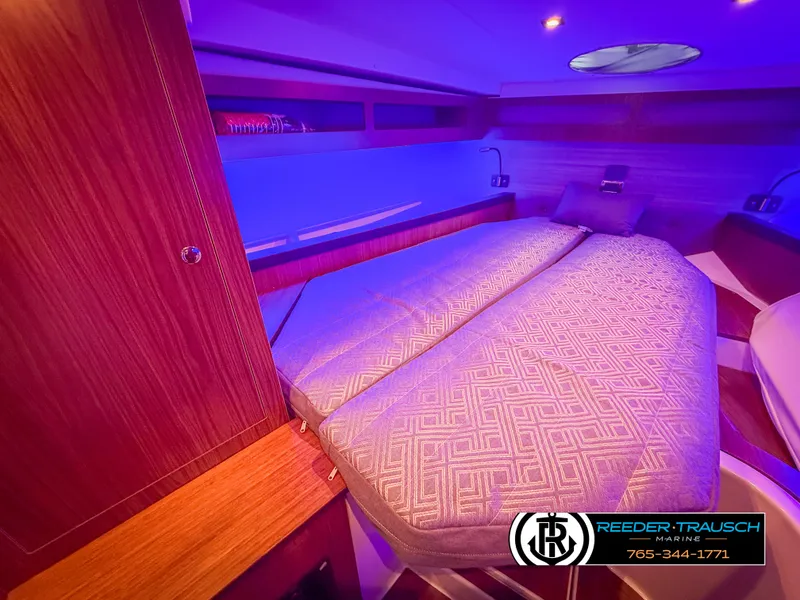 Slide: The Image of 2021 Four Winns Vista 355 Coupe OB cabin with cozy bed and ambient lighting. - 22