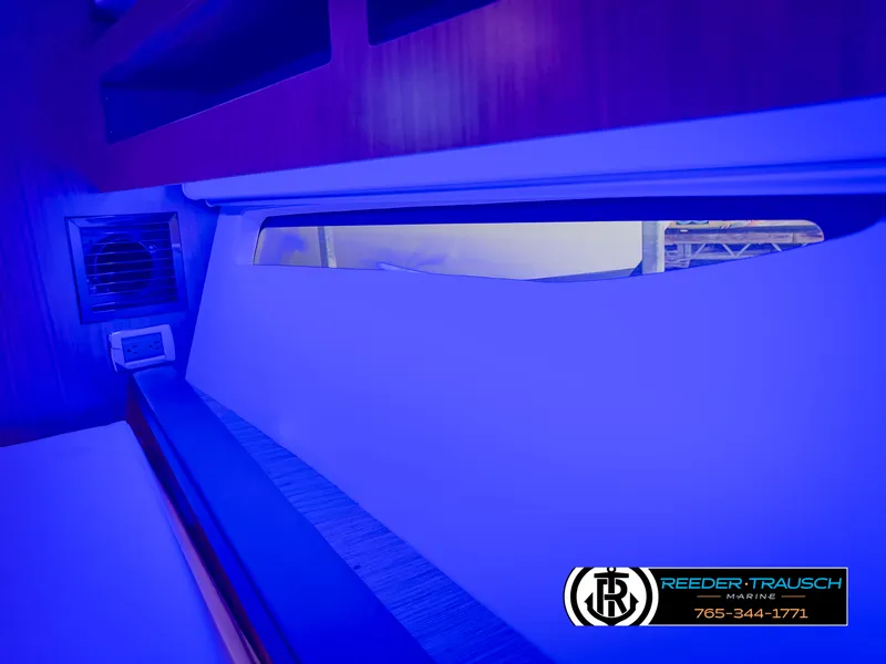 Slide: The Image of Interior view of 2021 Four Winns Vista 355 Coupe OB with blue lighting. - 24