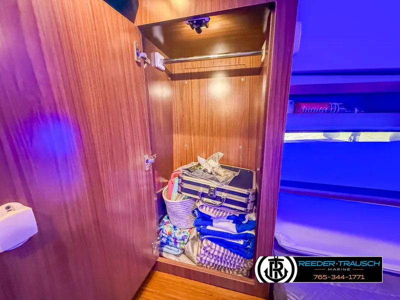 Slide: The Image of Open cabinet in 2021 Four Winns Vista 355 Coupe OB, storing various items. - 29