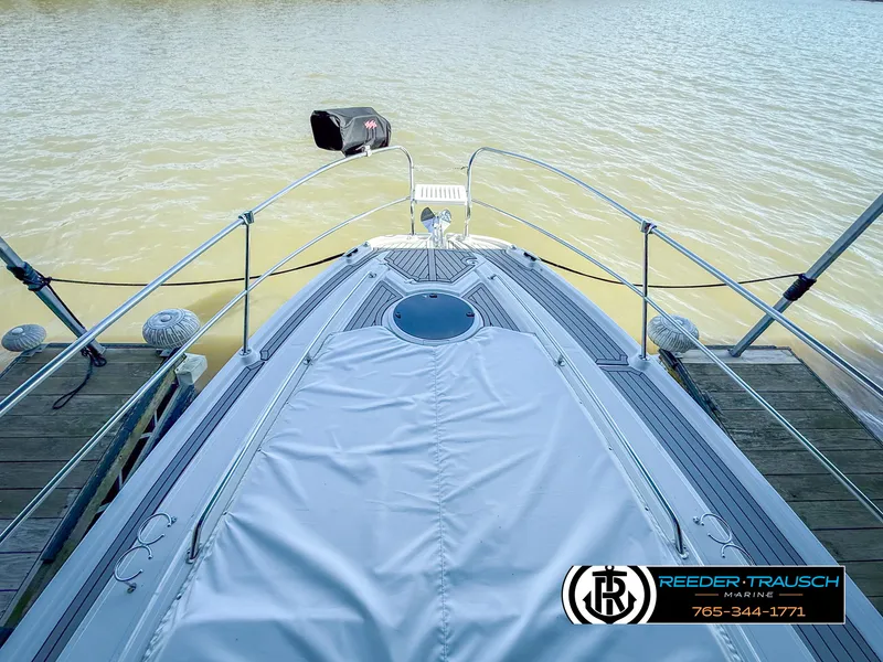 Slide: The Image of 2021 Four Winns Vista 355 Coupe OB boat docked, view from bow, Reeder-Trausch Marine logo visible. - 3