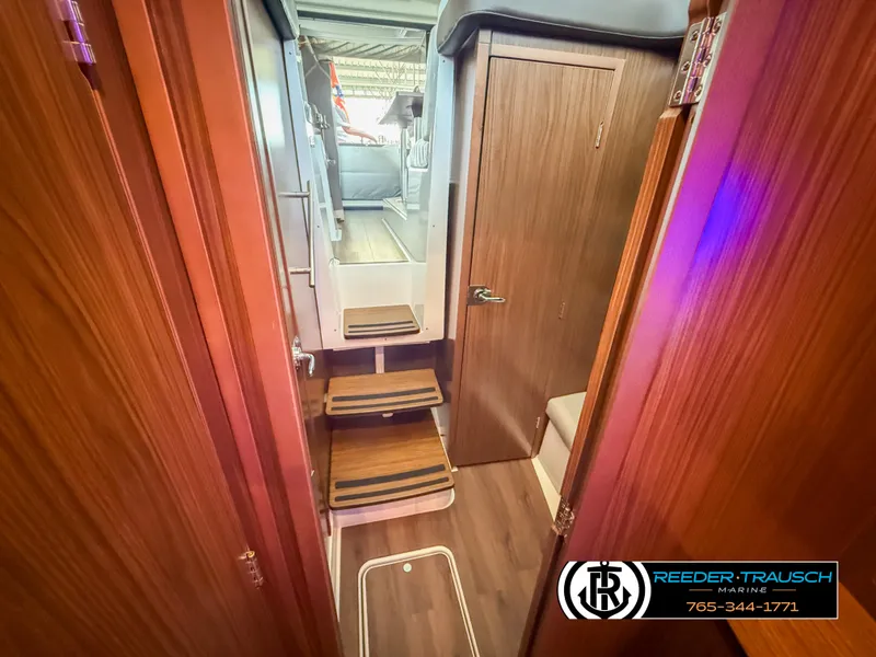 Slide: The Image of Interior view of 2021 Four Winns Vista 355 Coupe OB, featuring wooden finishes and compact design. - 30