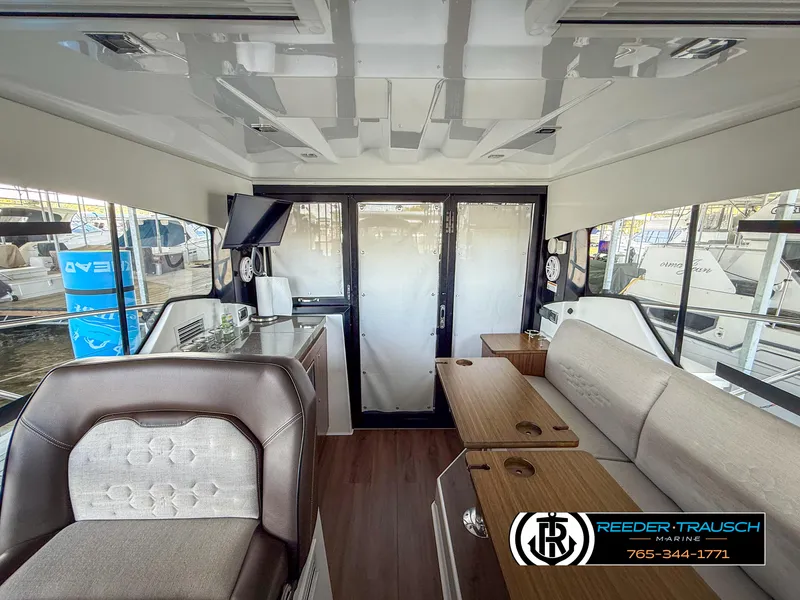 Slide: The Image of Interior of 2021 Four Winns Vista 355 Coupe OB, featuring modern seating and sleek design. - 31