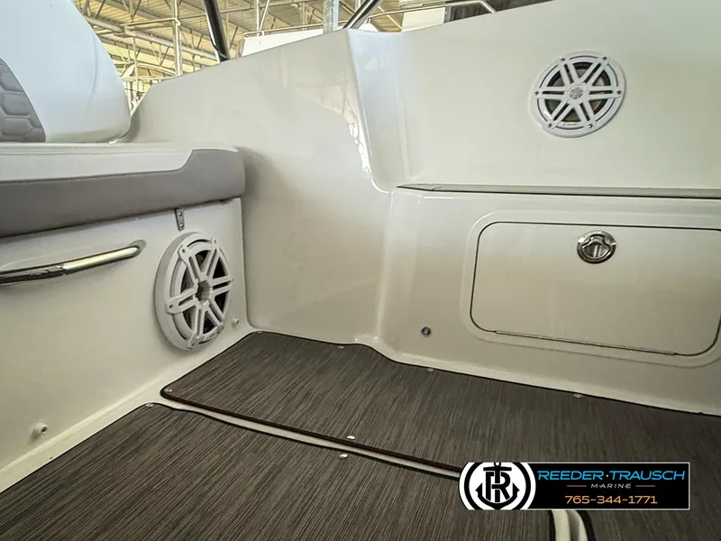 Slide: The Image of 2021 Four Winns Vista 355 Coupe OB interior with speakers and storage compartment. - 33