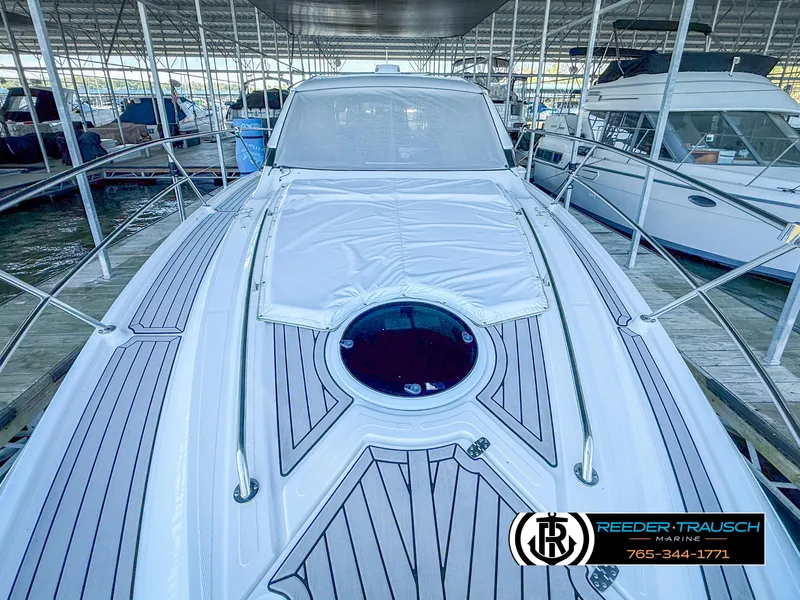 Slide: The Image of 2021 Four Winns Vista 355 Coupe OB docked, showcasing sleek deck design and modern features. - 4