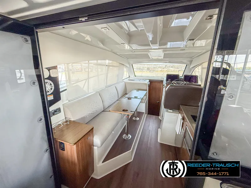 Slide: The Image of Interior of 2021 Four Winns Vista 355 Coupe OB, featuring modern seating and dining area. - 7