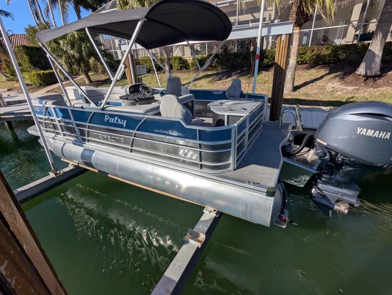 Slide: The Image of 2024 Trifecta 22TRFC LE 2.75 pontoon boat docked with Yamaha outboard motor. - 10