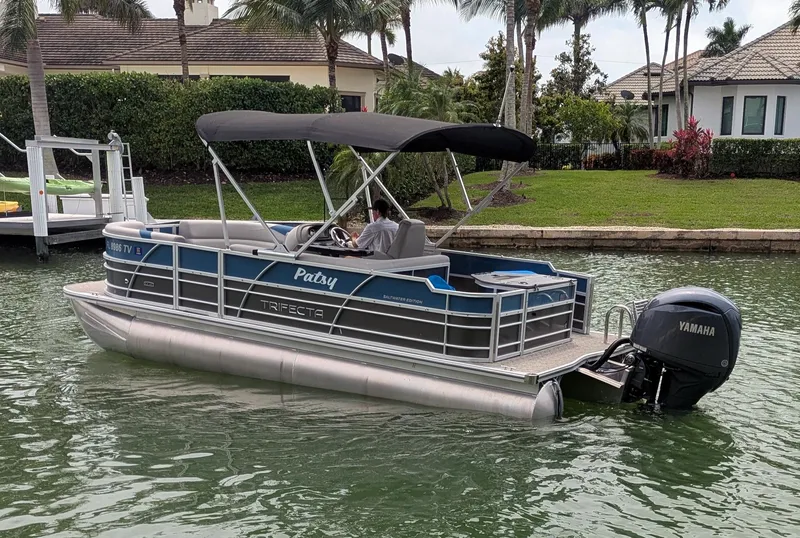 Slide: The Image of 2024 Trifecta 22TRFC LE 2.75 pontoon boat on water, featuring Yamaha outboard motor. - 12