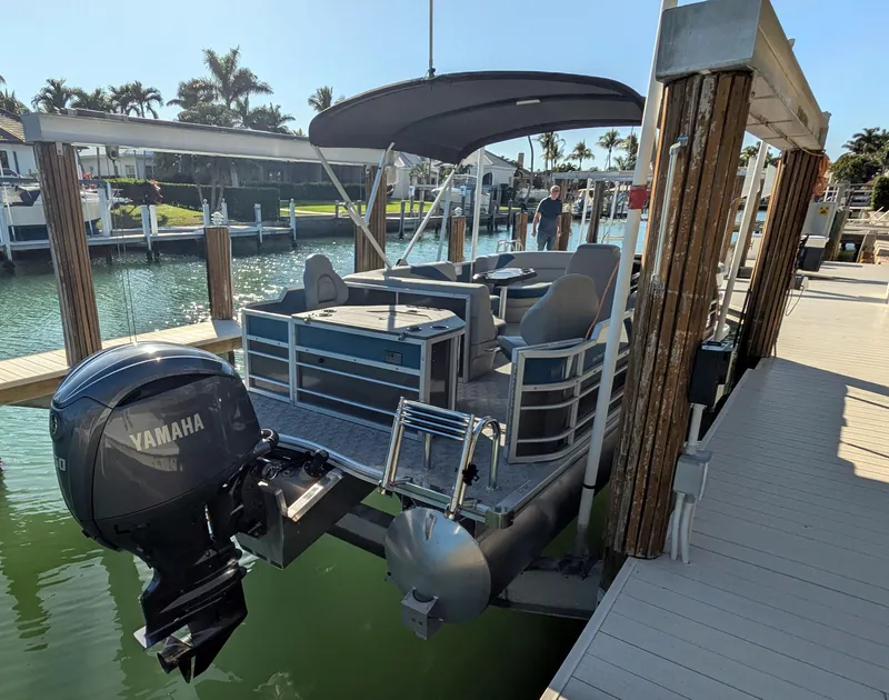 Slide: The Image of 2024 Trifecta 22TRFC LE 2.75 pontoon boat docked with Yamaha outboard motor. - 13
