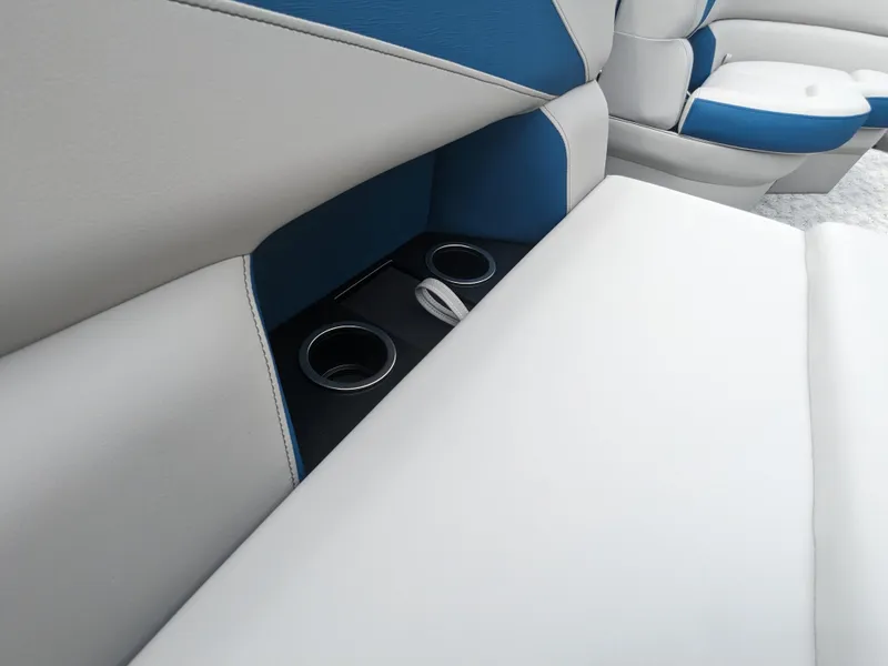 Slide: The Image of 2024 Trifecta 22TRFC LE 2.75 boat interior with cup holders and blue-white seating. - 24