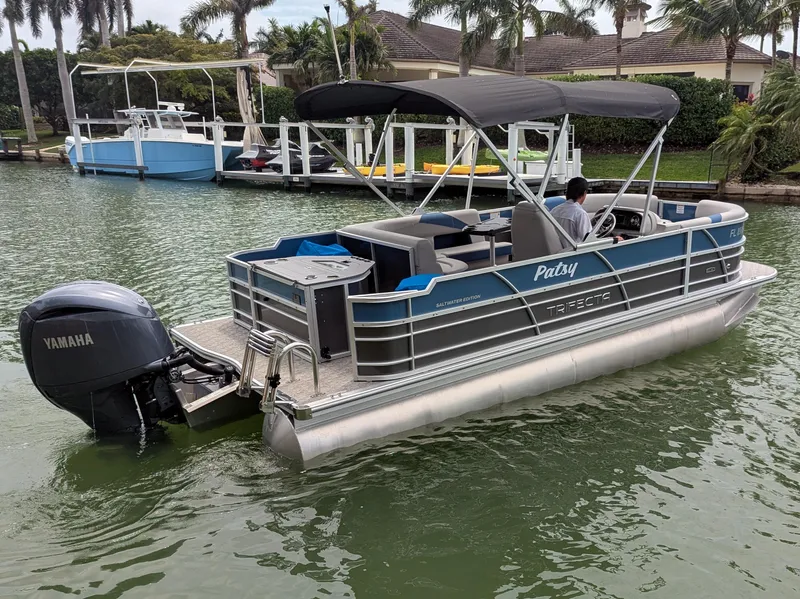 Slide: The Image of 2024 Trifecta 22TRFC LE 2.75 pontoon boat on water with Yamaha outboard motor. - 9
