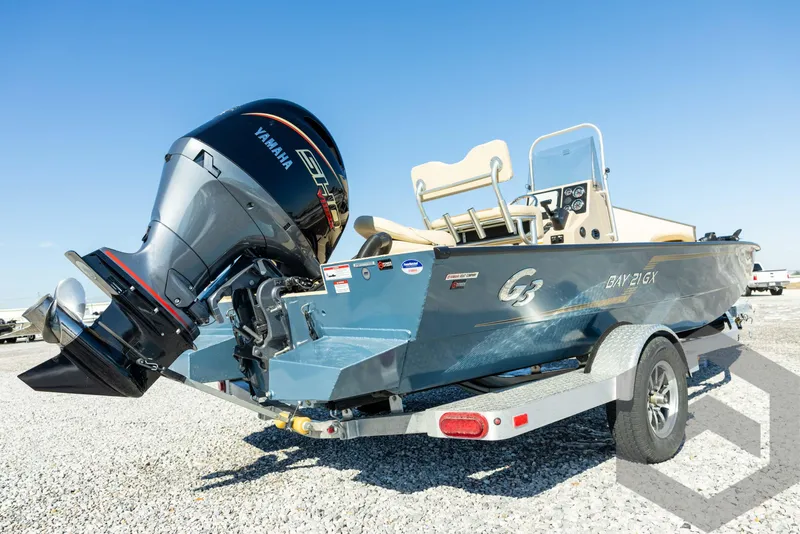 Slide: The Image of 2025 G3 Bay 21 GX boat on trailer with Yamaha outboard motor. - 14