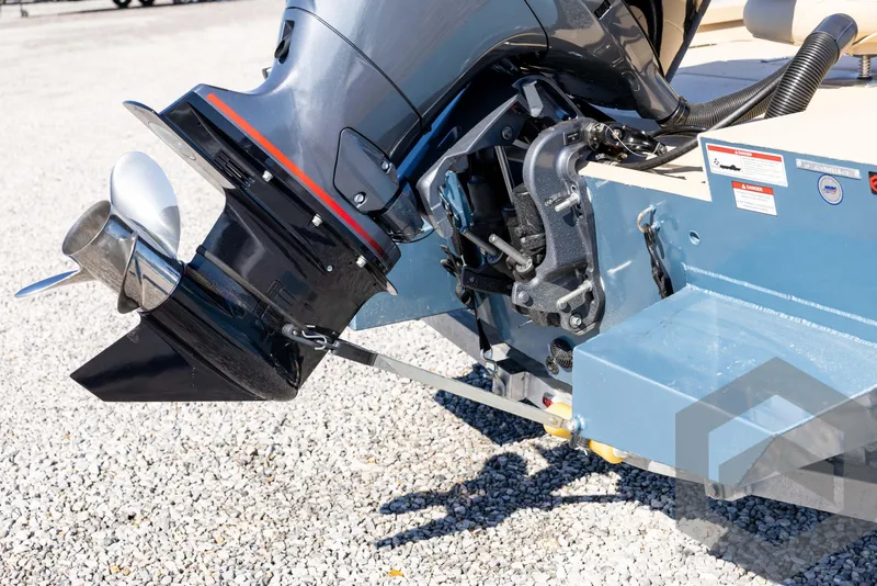 Slide: The Image of 2025 G3 Bay 21 GX boat motor and propeller on gravel surface. - 15