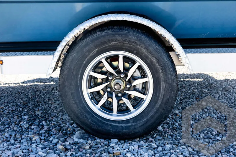 Slide: The Image of 2025 G3 Bay 21 GX trailer wheel on gravel surface. - 21