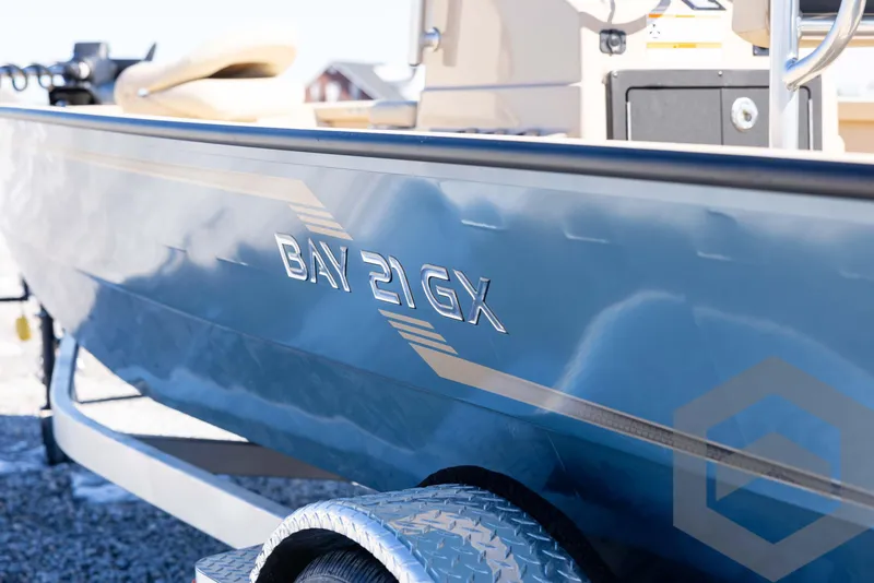 Slide: The Image of 2025 G3 Bay 21 GX boat side view with logo and trailer. - 23