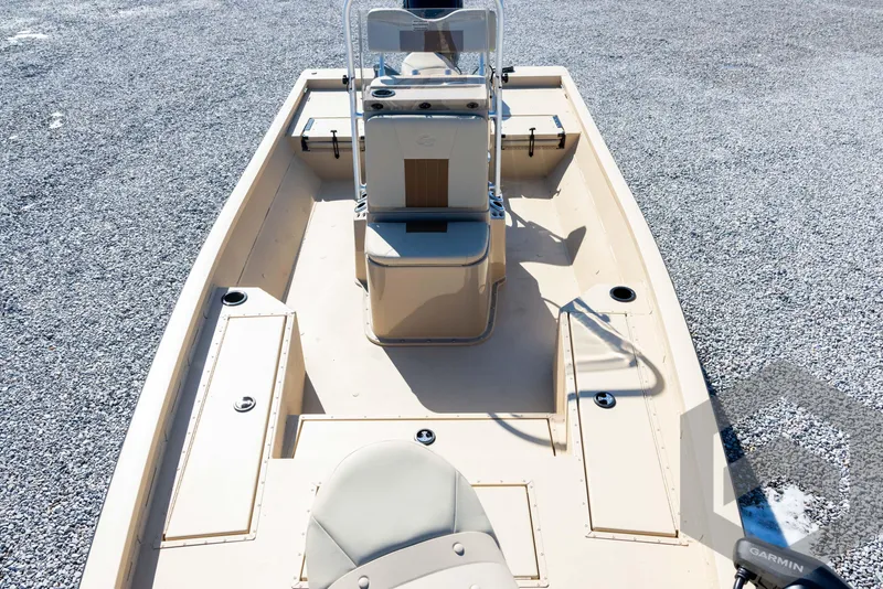 Slide: The Image of 2025 G3 Bay 21 GX boat interior with seating and console on gravel surface. - 28