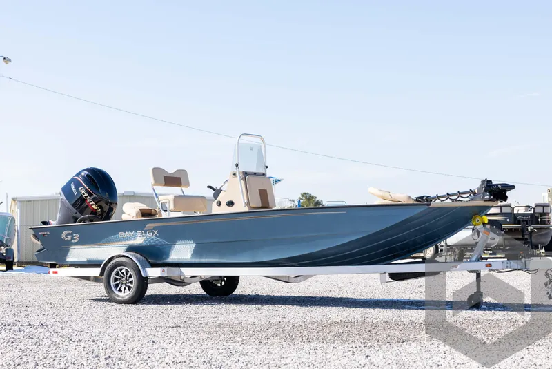 Slide: The Image of 2025 G3 Bay 21 GX boat on trailer, parked on gravel lot. - 3