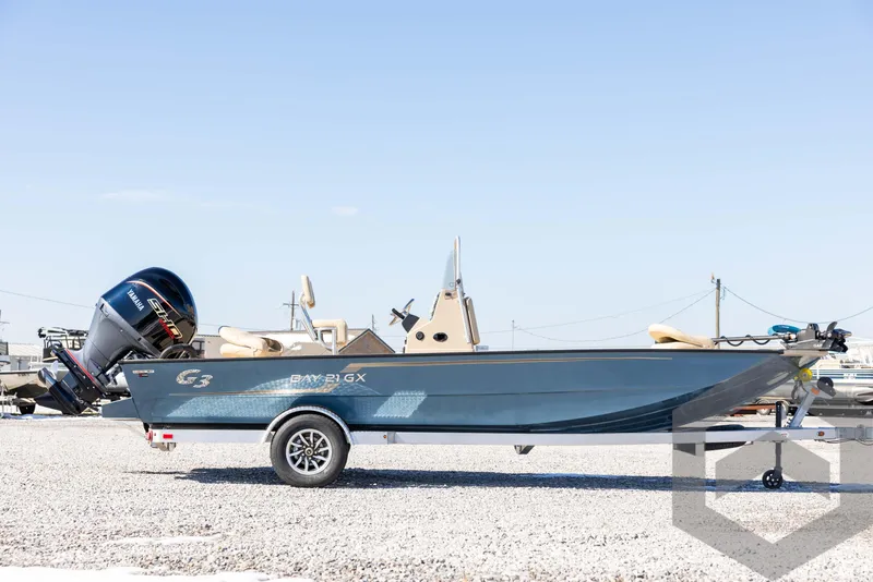 Slide: The Image of 2025 G3 Bay 21 GX boat on trailer, parked outdoors on gravel. - 4