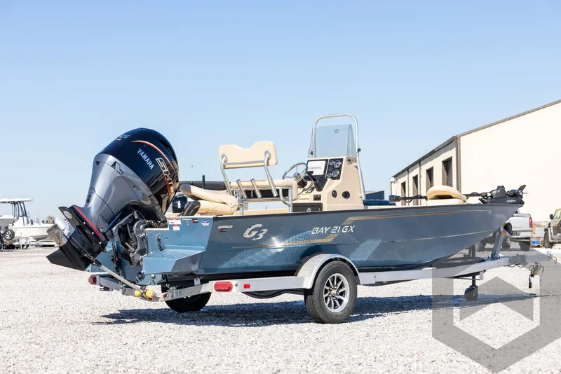 Slide: The Image of 2025 G3 Bay 21 GX boat on trailer, outdoor setting, clear sky. - 5