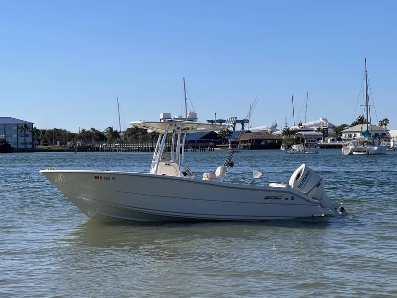 Slide: The Image of 2020 Bulls Bay 230 CC boat on calm water with marina background. - 0
